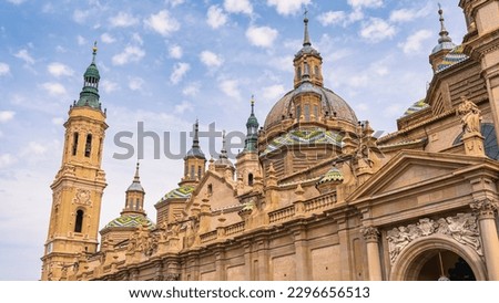 Domes with brightly colored tiles and Mudejar style towers of the basilica and cathedral of El Pilar, Zaragoza, Spain.