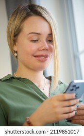 Domestic Abuse Victim With Face Scars And Prosthetic Eye Using Mobile Phone At Home During Lockdown. Violence Survivor Woman With Facial Scar Living Happy Life And Communicating Online With Smartphone