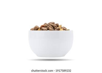 domestic animals dry food at white bowl isolated on white background. dried cat feed cut out. above view.