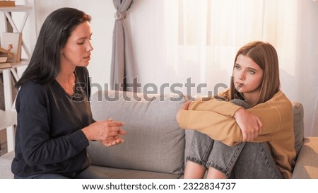 Domestic blaming. Upbringing problem. Criticizing mother talking with teenage daughter about life and responsibility sitting light home interior.