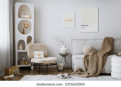 Domestic and cozy christmas living room interior with mock up poster frames, beige sofa, design armchair, christmas decoration, wreath, stars, gifts and accessories. Family time. Template. - Powered by Shutterstock