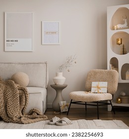 Domestic and cozy christmas living room interior with mock up poster frames, beige sofa, design armchair, christmas decoration, wreath, stars, gifts and accessories. Family time. Template.