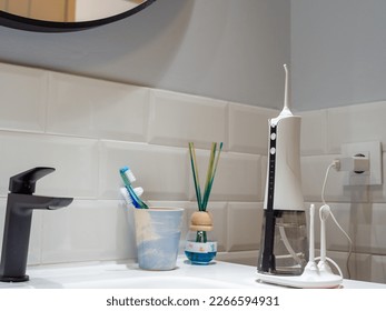 domestic dental water flosser on the bathroom wash basin - Shutterstock ID 2266594931