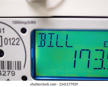 A Domestic Electric Smart Meter Close-up. Green LCD Display Shows Current Bill. Concept For Energy Bills, Price Rise, Inflation, Cost Of Living And Meter Reading. Windfall Tax.