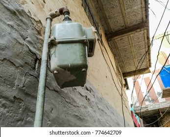 A Domestic Gas Reader Meter Is Fixed Outdoor On The Concrete Wall In A Congested City 