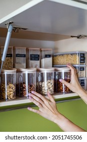 Domestic Healthy Vegetarian Dry Food Storage Organization On Shelf At Kitchen Cupboard. Comfortable Neatly Keeping Arrangement In Glass Containers Oat Flakes, Wheat Flour, Sugar, Pasta, Nuts, Rice