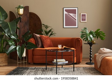 Domestic interior of living room with design sofa, mock up poster frames, a lot of plants, coffee table, room screen, pouf and elegant personal accessories in modern home decor. Template.