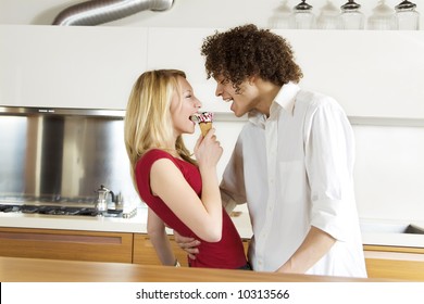 domestic life: interracial couple eating an ice cream - Powered by Shutterstock