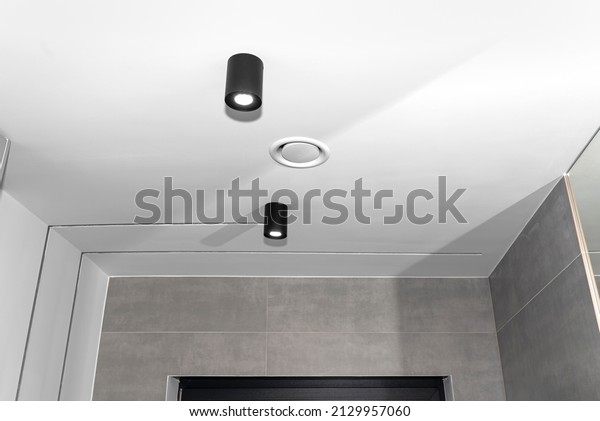 Domestic mechanical\
ventilation with heat recovery, a visible exhaust anemostat on the\
ceiling in the room.