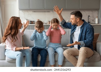 Domestic Quarrels. Man And Woman Arguing In Front Of Their Kids At Home, Upset Preteen Siblings Covering Ears With Hands Not To Listen Conflict, Stressed Children Sitting Between Shouting Parents - Powered by Shutterstock