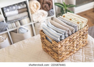 Domestic textile bed linen neatly placed cupboard shelves minimalism Nordic storage method closet organization. Decorative potted plants on cabinet shelf fabric blanket sheet duvet pillow arrangement