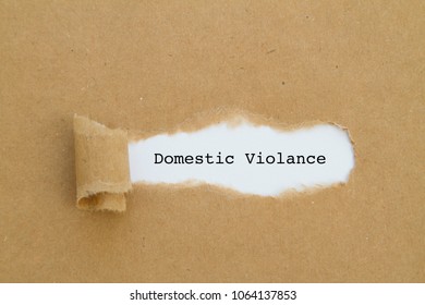 Domestic Violance Word Written Under Torn Paper.