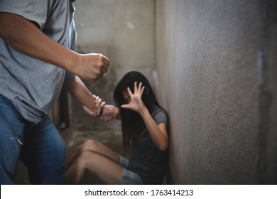 Domestic violence against a woman, Sexual abuse with a man attacking to a scared woman in a dark place, stop violence against Women,