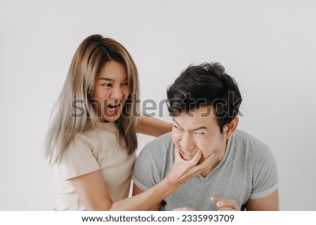 Domestic violence of asian wife hitting husband isolated on white.