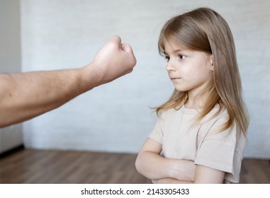 Domestic Violence Concept. Father  Shouting At His Child. Unrecognizable  Man Threatening Daughter With His Fist.