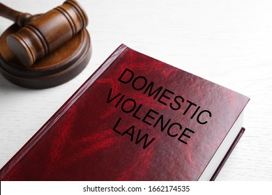 Domestic violence law and gavel on white wooden table, closeup - Shutterstock ID 1662174535