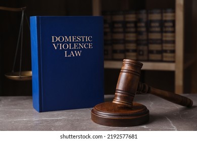 Domestic violence law and gavel on grey marble table - Shutterstock ID 2192577681
