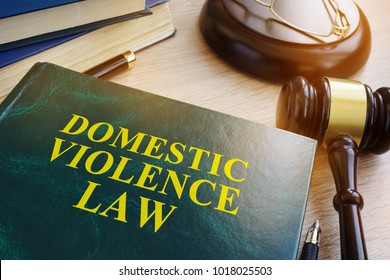Domestic violence law on a wooden table. - Shutterstock ID 1018025503