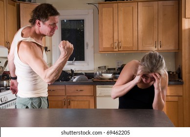 domestic violence - man with clenched fist threatens woman