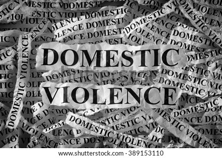 Domestic violence. Torn pieces of paper with the words Domestic violence. Concept Image. Black and White. Closeup.