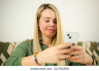 Domestic Violence Victim With Facial Scar And Prosthetic Eye Typing Message On Modern Mobile Phone With Cheerful Smile. Abuse Survivor Woman Living Happy Life