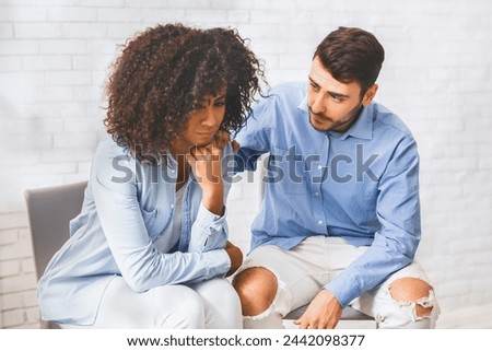 Domestic violence victim. Supportive people comforting depressed black woman at group therapy meeting at counselor's office