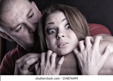 Domestic violence woman being abused and strangled by strong man