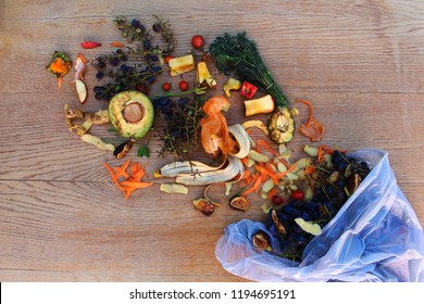 Domestic waste for compost from fruits and vegetables in the garbage bag on the table. - Shutterstock ID 1194695191
