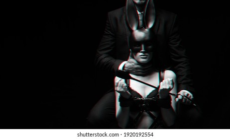 dominant man with a whip Flogger and a submissive girl in handcuffs and a face mask. Black and white with 3D glitch virtual reality effect