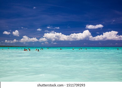 DOMINICAN REPUBLIC, BAYAHIBE, CATALONIA GRAN DOMINICUS HOTEL -12 JUNE 2019: Happy Group Of People Swimming In A Carribean Sea