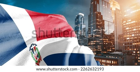 Dominican Republic national flag cloth fabric waving on beautiful building background.