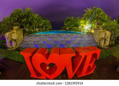 Dominican Republic, Punta Cana, Bavaro - January 5, 2019. Celebration Of St. Valentine's Day On The Tropical Islands. Luxury Vacation. Inscription Love On The Background Of Exotic Palms And Night Sky
