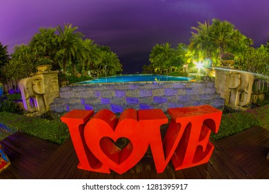 Dominican Republic, Punta Cana, Bavaro - January 5, 2019. Celebration Of St. Valentine's Day On The Tropical Islands. Luxury Vacation. Inscription Love On The Background Of Exotic Palms And Night Sky
