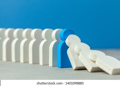 Domino Effect In Business. One Businessman Falls And Brings Down Other Figures Of Employees. Prevent The Destruction Of The System. Crisis Manager Stops Falling Dominoes