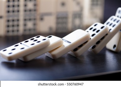 Domino effect shot on black background 