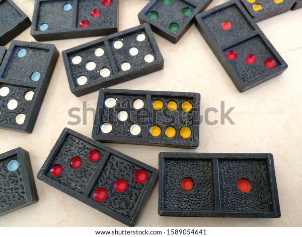 Domino game divided into two squares having 0 to 6\
dots as in dice.