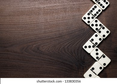 domino pieces forming zigzag on wooden table