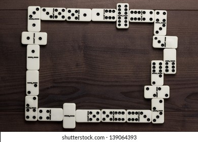 domino pieces on dark brown wooden background