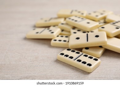 Domino tiles on wooden table. Space for text
