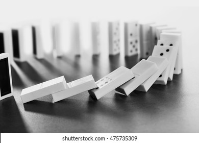 Dominoes Falling On Gray Background