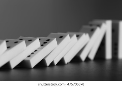 Dominoes Falling On Gray Background