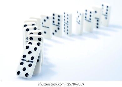 Dominoes On Plain Background, About To Fall