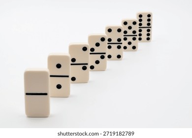 Dominoes in a row ordered progressively representing growth and continuous progress