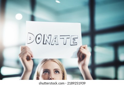 Donate, Volunteer And Give Back To The Community With A Sign In The Hands Of A Young Woman Inside. Closeup Of A Poster With Text Looking For Welfare Aid, Donations And Contributions To Society