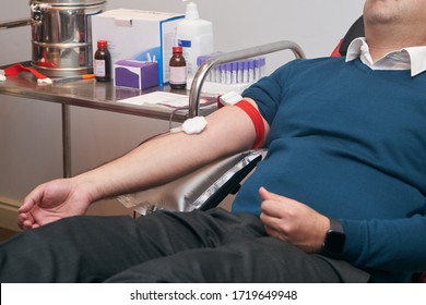 Donating Blood In Hospital, Close-up. Blood Donor At Donation Station. COVID-19 Coronavirus Survivor Patient Donating Blood Plasma