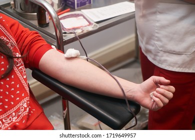 Donating Blood In Hospital, Close-up. Blood Donor At Donation Station. COVID-19 Coronavirus Survivor Patient Donating Blood Plasma