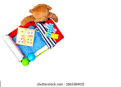 Donation Box With Baby Kid Toys, Books, Clothing For Charity On White Background. Top View