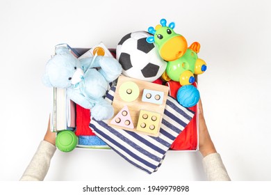 Donation Box With Baby Kid Toys, Books, School Supplies, Clothing For Charity On White Background. Top View