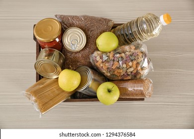 Donation Box With Food On Wooden Table, Top View