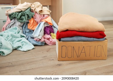 Donation Box With Warm Clothes In The Room.